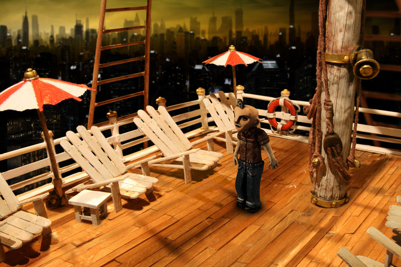 An environment from The Dream Machine featuring some lovely popsicle-stick chairs.